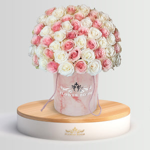 pink and white roses in a pink marble box