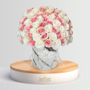 pink and white roses in a marble box