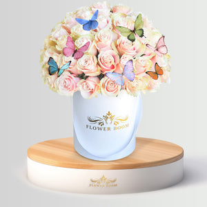 light pink roses in a box with butterflies