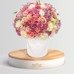 Flower Boom San Francisco Signature roses, pink spray roses, lisianthus & more in a white round box