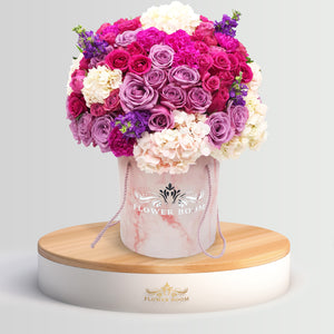 Fresh FbSF lavender, purple roses, blue hydrangeas, purple calla-lilies, violet & purple flowers in a pink marble round box