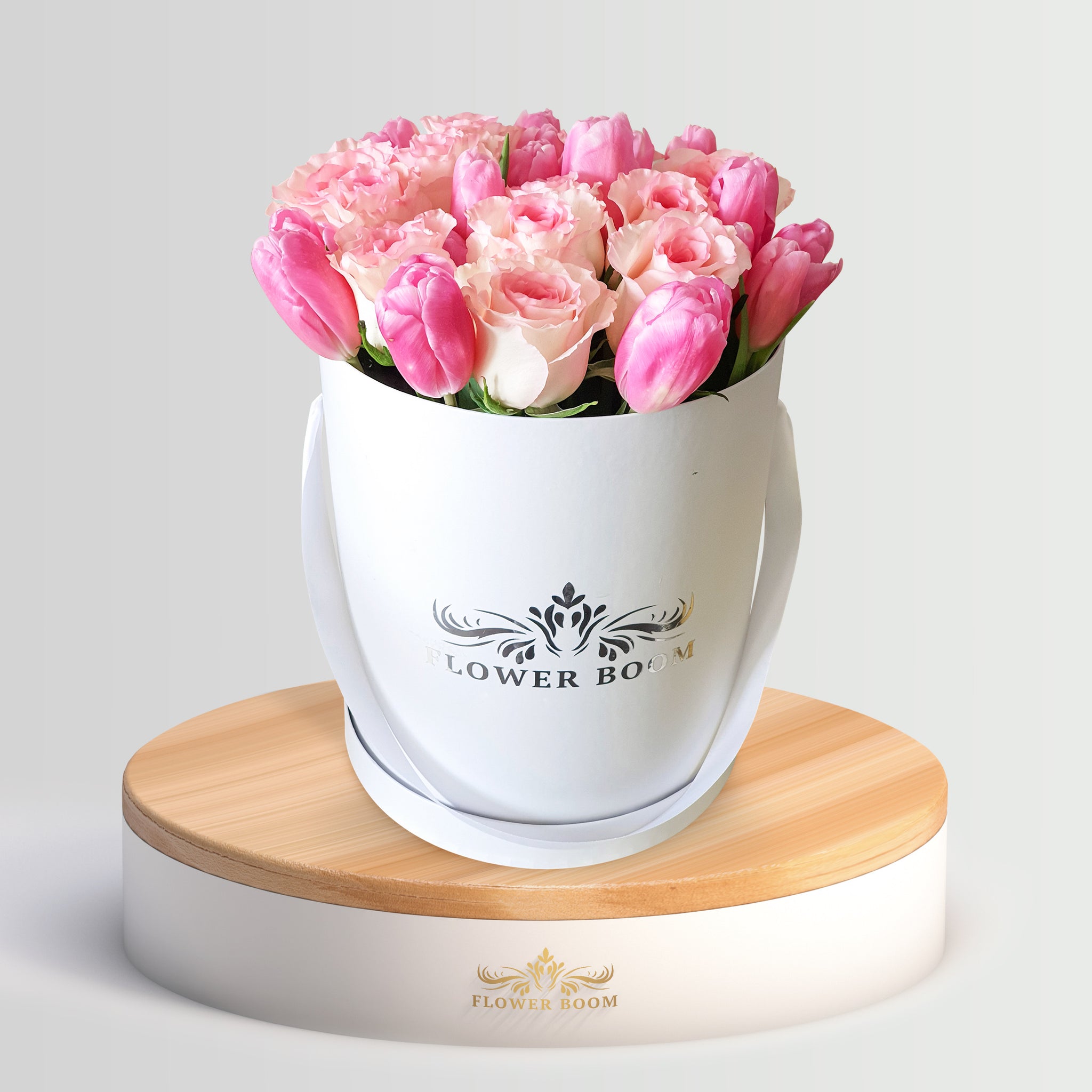 pink roses and tulips in a round box