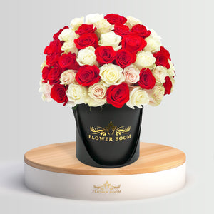 white red and light pink roses in a box