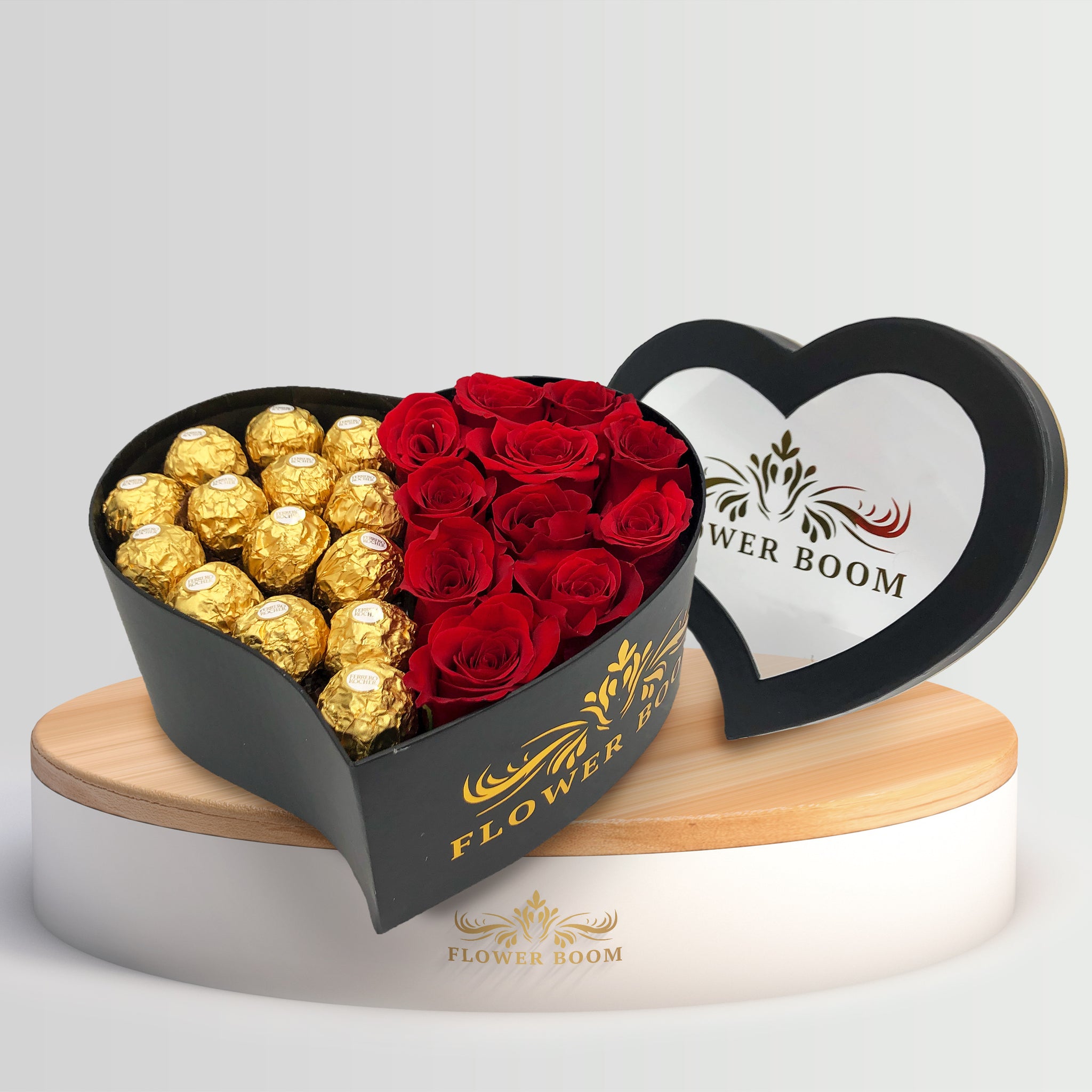 ferrero rocher chocolates with red roses in a heart shaped black box