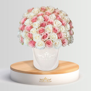 pink and white roses in a white box